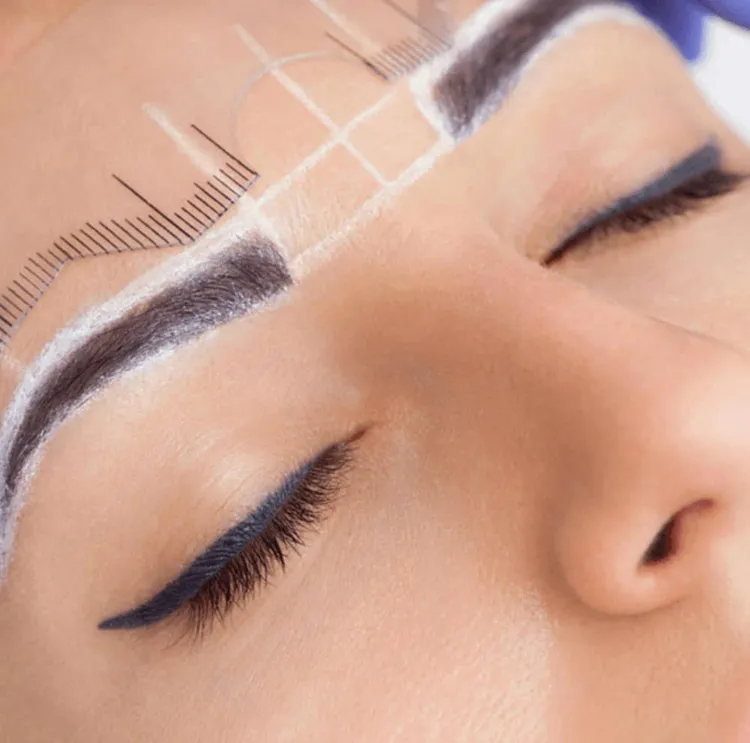 Close view of a woman's finished permanent eyebrows with a natural, full shape